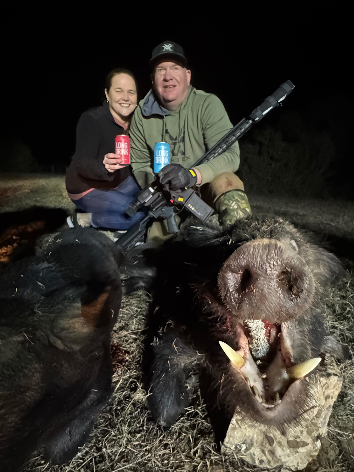 Jon and Tracie pose with the boar that clinched the $100 bet and capped off an unforgettable trip.