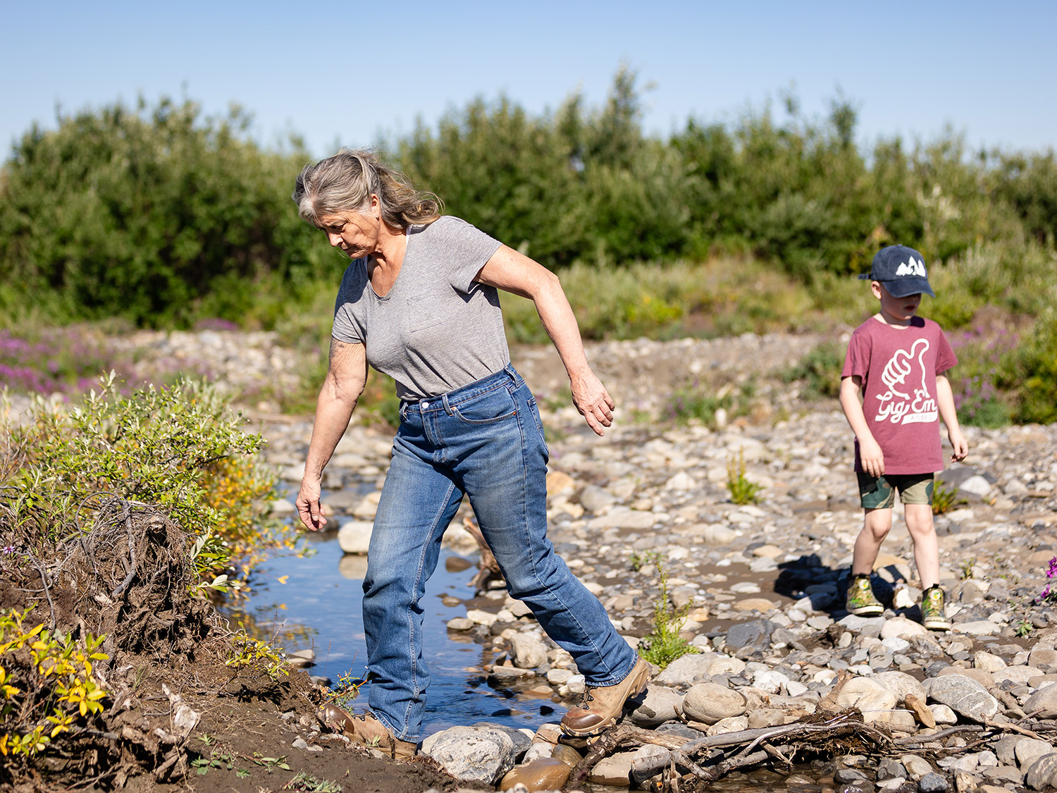 Sue Aikens Crossing Arctic Creek with Knox at Kavik River Camp Sue Aikens Crossing Arctic Creek with Knox at Kavik River Camp<br />